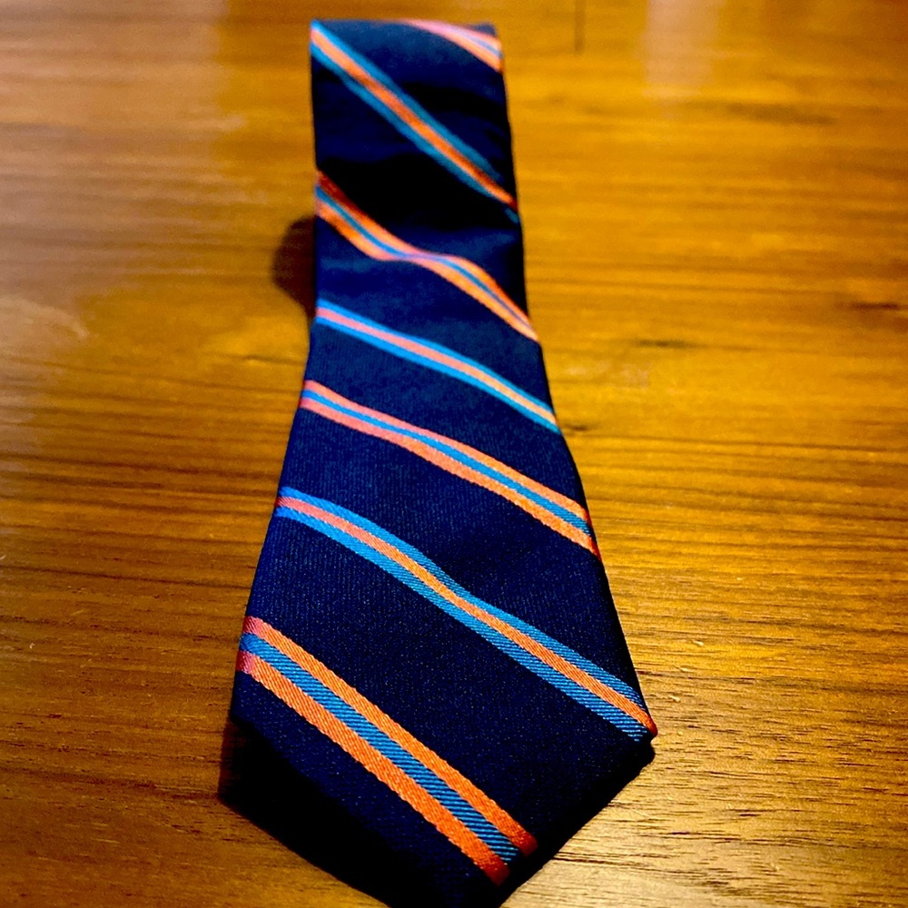 Thin Original Penguin Tie in Navy Blue with salmon and light blue stripes.